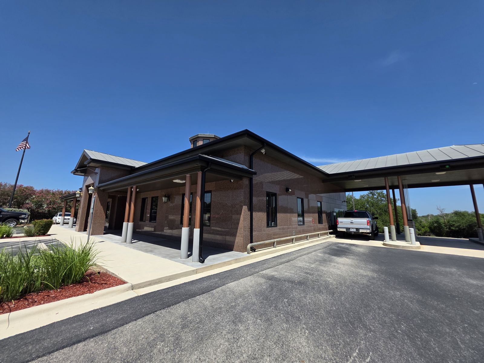 commercial gutters and downspouts on a bank building and drive through canopy