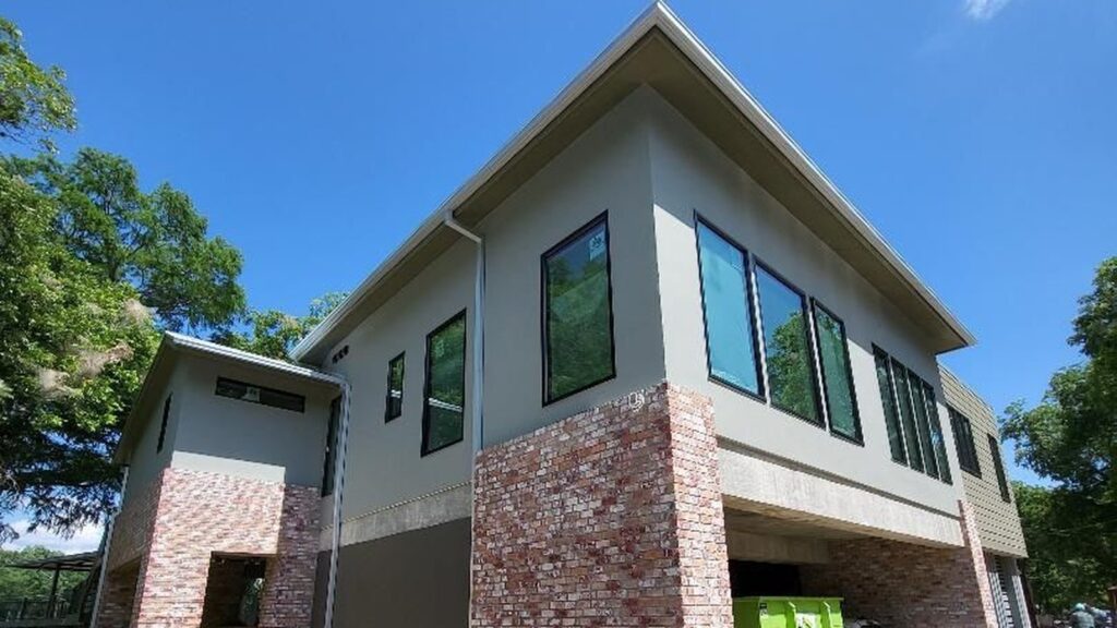 Galvalume steel or aluminum gutters for a Central Texas home? How hail, sun and ladders change the answer